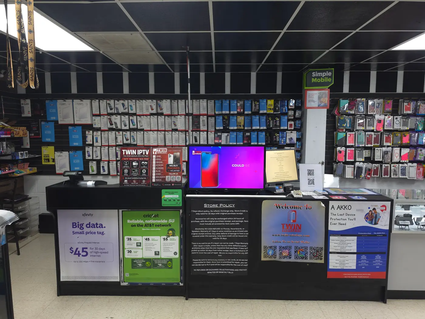 Inside Twin Wireless in Shreveport, showing the service counter and the wall of phone cases and screen protectors